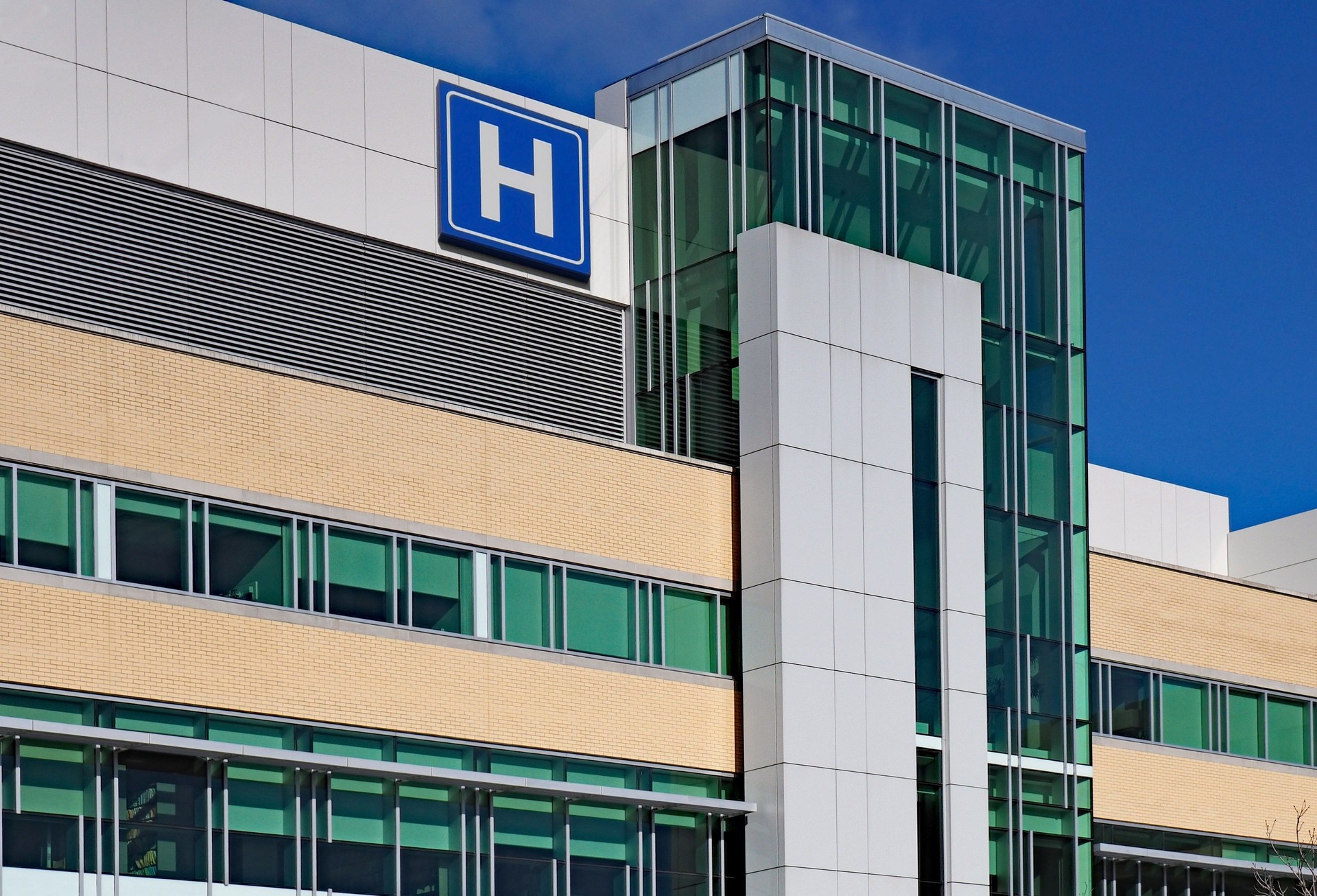 building with large H sign for hospital, healthcare industry, flooring options and installation
