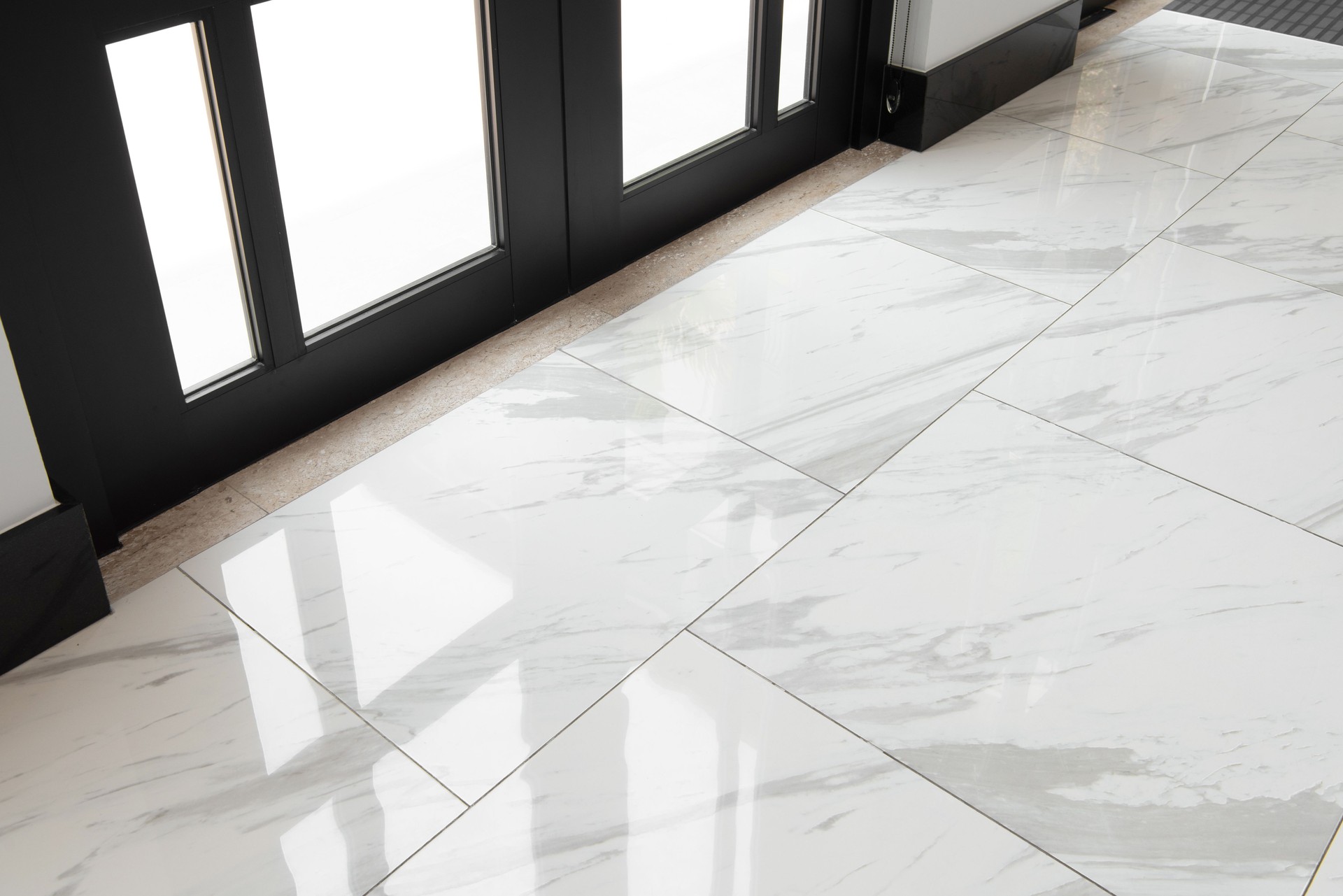 Marble ceramic floor tiles in the glass door. Ceramic tile floor installation